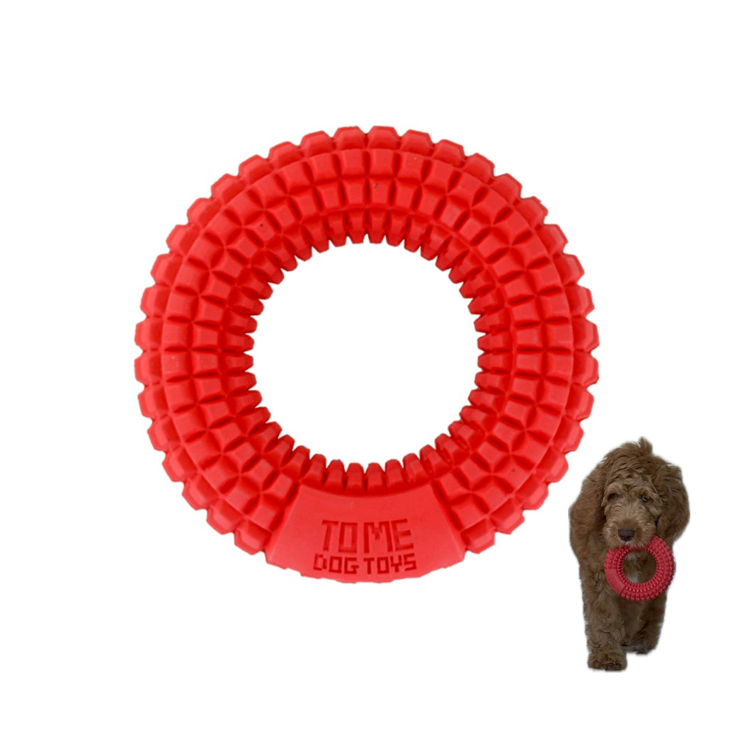 Red textured rubber chew ring toy featuring small raised bumps all around its surface, designed for medium to large aggressive chewers to chew, fetch, and promote dental health.